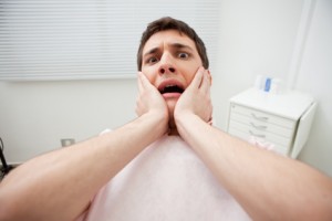 Patient in dentist's office afraid of treatment